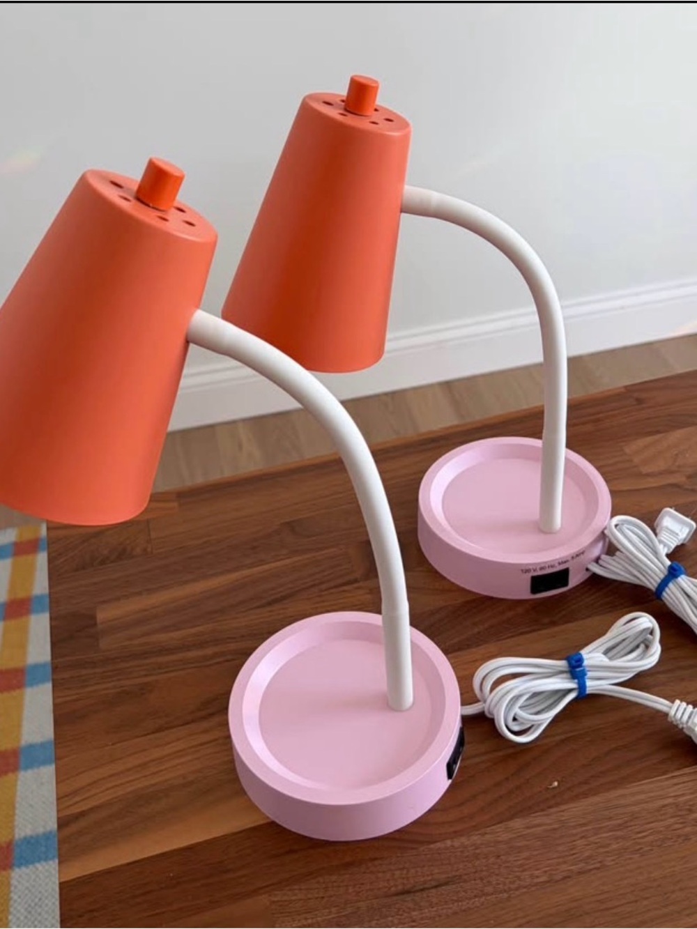 Pink and orange pair of desk lamps